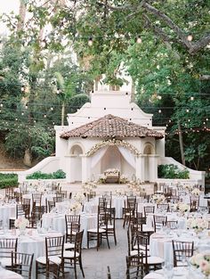 an outdoor wedding venue set up with tables and chairs