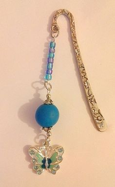 a blue beaded key chain with a butterfly charm attached to it's end