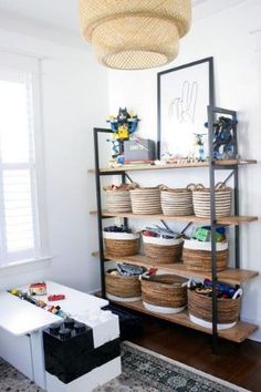 a living room filled with lots of furniture and baskets on top of bookshelves