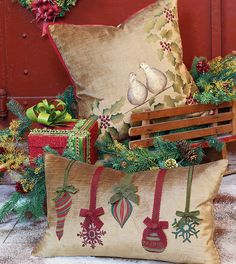 two christmas pillows sitting next to each other