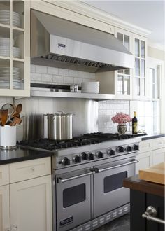 an image of a kitchen setting with pots and pans on the stove top oven