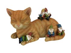 a cat that is laying down with some gnomes on it's back and eyes closed