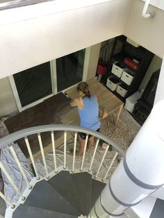 a woman standing on top of a spiral staircase