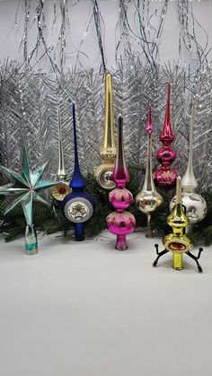 a group of christmas ornaments sitting next to each other on top of a white table