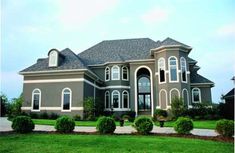 a large brown house with lots of windows