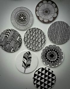 six black and white coasters with designs on them