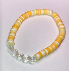 Cute yellow and white beaded bracelet. These are high quality handmade bracelets. They are made with an elastic string so will fit lots of sizes. They are around 6.75 inches. Please note that each braclet will have a very similar beading pattern but not exactly identical. Yellow Clay Bead Bracelet, Bracelet Clay, Clay Beaded Bracelet, White Beaded Bracelet, Bracelet Cute, Small Business Packaging Ideas, Yellow Bracelet, Cute Bracelet, Business Packaging