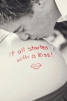 a man is kissing his pregnant belly with the words it all started with a kiss