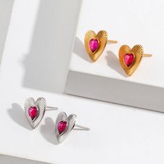 hese earrings feature a vintage-inspired design with a heart-shaped motif. They are made of pure silver and are plated with gold, giving them a luxurious and timeless look. The earrings are lightweight and comfortable to wear, making them suitable for everyday wear or special occasions. The heart-shaped design adds a touch of romance and femininity to any outfit, making them a great gift option for a loved one or a beautiful addition to your own jewelry collection. Remove your earrings when performing certain activities: Avoid wearing your 925 sterling silver earrings when exercising, swimming, showering, or sleeping. These activities can expose your earrings to moisture and chemicals that can cause tarnishing and discoloration. Clean your earrings regularly: To prevent tarnishing, clean y Gold-plated Silver Heart Earrings Tarnish Resistant, Tarnish Resistant Silver Gold-plated Heart Earrings, Silver Gold-plated Tarnish-resistant Heart Earrings, Silver Tarnish-resistant Gold-plated Heart Earrings, Silver Heart-shaped Gold-plated Earrings, Metal Heart Pendant Earrings For Anniversary, Gold Plated Earrings For Valentine's Day Gift, Heart-shaped Metal Earrings For Valentine's Day, Heart Shaped Metal Earrings For Valentine's Day