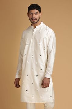 Ivory kurta with mirror embroidered motifs and front button placket. Paired with pant.
Component: 2
Embroidered
Neckline: Mandarin
Sleeve Length: Full
Fabric: Cotton Silk
Color: White
Front button placket - Aza Fashions Mirror Work Kurta, Silk Kurta Set, Embroidered Motifs, White Kurta, Indian Wedding Wear, Silk Kurta, Classic Pants, Ivory Silk, Embroidered Neckline