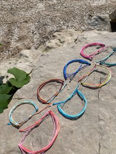 four pairs of glasses sitting on top of a rock