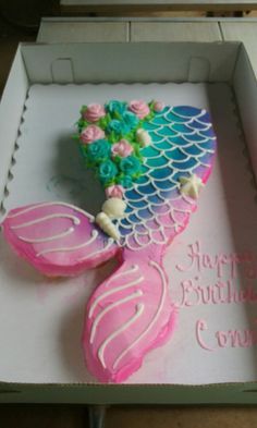 a decorated cake in the shape of a mermaid