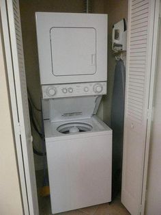 a white washer and dryer sitting in a laundry room next to each other