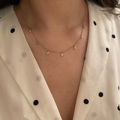 The Orbits Diamond Drop Choker Necklace in 14k Gold is classic, delicate, and modern. It shines like little stars orbiting around a galaxy. It is the perfect necklace to add a little sparkle to your neck with the right amount of sophistication. Wear it on its own for a fun and dainty feel, or pair it with your favorite chains and necklaces for a fun layer. It surely complements every outfit! Diamonds (0.28 ct) 14k yellow gold Adjustable from 16 to 18" Drop dimensions: 3mm Please allow up to 6 we Dainty Diamond Necklace With Satellite Chain, Dainty Diamond Necklace With Delicate Chain, Sparkle Hoop Earrings, Apply Perfume, Soft Jewelry, Gold Butterfly Ring, Boulder Opal Necklace, Halo Necklace, Heart Necklace Diamond