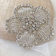 a brooch that is sitting on a cloth