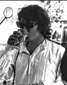 black and white photograph of a man drinking from a cup