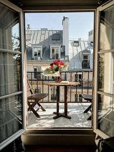 an open window shows a table with flowers on it