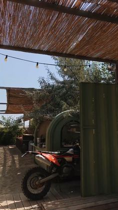 a dirt bike is parked under a roof