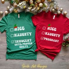 two t - shirts that say nice, mighty, innocent and arrogant with christmas decorations in the background