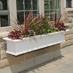 a white window box with plants in it