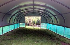 the inside of a large tent with grass in it