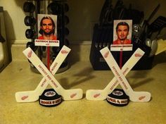 two hockey trophies with photos of the same player and name on them, in front of a kitchen counter