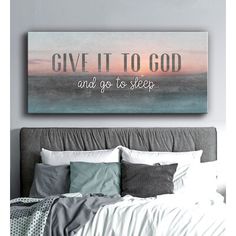 a bedroom with a bed and a painting above it that says give it to god and go to sleep