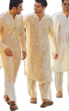 three men in white outfits standing next to each other, one wearing sunglasses and the other with