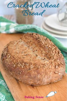 a loaf of bread sitting on top of a wooden cutting board