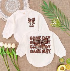 Personalised Game Day Baby Romper, Vintage Coquette Football Bow Romper Sweatshirt, Football Sport Baby Outfit, Matching Baby Clothes - Handmade  - Ships from USA  - Materials: 100% CPSIA Compliant and Ethically Made material Light fabric (5.0 oz/yd² (170 g/m  Crafted with soft, breathable fabric, this romper ensures your baby stays comfortable through playtimes and nap times alike. Featuring charming designs suitable for all babies, our romper is as adorable as it is practical.  Quick Sizing Ti Graphic Print Long Sleeve Top For First Birthday, White Long Sleeve Tops For First Birthday, White Tops With Name Print For Playtime, Nap Times, M Craft, Outfit Matching, Sports Baby, Vintage Coquette, Matching Baby