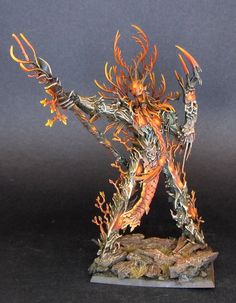 a statue is shown with flames on its body and arms, as if it were made out of metal