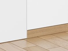 a white cabinet sitting on top of a hard wood floor