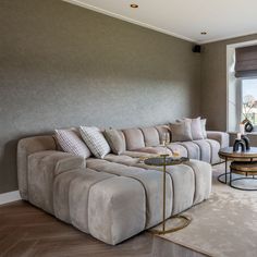 a living room filled with furniture and a large window