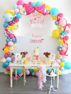 a birthday party with balloons, cake and decorations