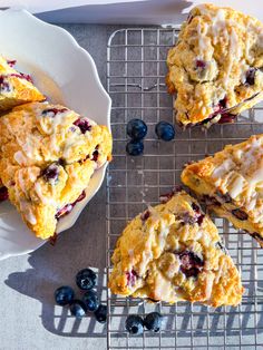 blueberry scones on a cooling rack with fresh berries