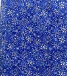 blue and white snowflakes are arranged in the shape of an intricate pattern on fabric