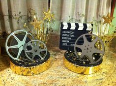 two movie reels sitting next to each other on top of a marble countertop