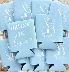 six blue flasks with the words drunk in love printed on them sitting on top of each other