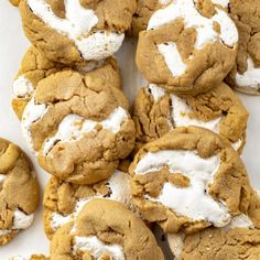 a pile of cookies with white frosting on top