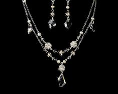 "Stylish and elegant, this silver or gold plated necklace and earring set is the perfect accessory for your wedding, honeymoon or special occasion. The set features freshwater pearls and clear Swarovski crystals, the perfect finishing touch to your vintage chic or classic wedding dress. READY TO SHIP DETAILS: - Necklace: 15\" long with a 2.5\" adjustable extender, Earrings: 1.5\" long. - Earrings - 2\" (Length) - Offered in Gold or Silver COORDINATING SASHES, CUFF BRACELETS & FASCINATORS, VI Silver Costume Jewelry Sets For Weddings, Classic Silver Necklace For Mother Of The Bride, Silver Crystal Jewelry With Pearl Drop, Silver Jewelry Sets With Pearl Drop For Formal Occasions, White Gold Jeweled Wedding Jewelry, Elegant Silver Costume Jewelry Necklaces, Elegant Silver Dangle Jewelry Sets, Vintage Silver Bridal Necklace With Pearl Drop, Silver Crystal Jewelry Set With Pearl Drop