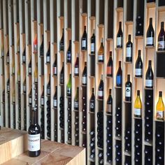 bottles of wine are lined up on the wall