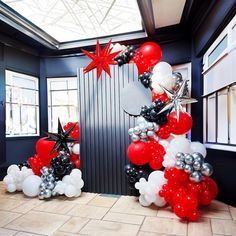 balloons are arranged in the shape of an arch with stars and snowflakes on it