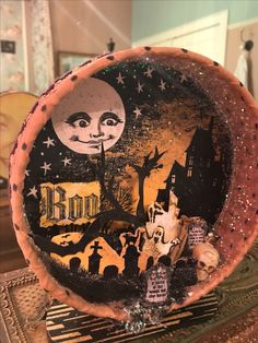 a decorative plate with an image of the moon and castle on it, sitting on a table