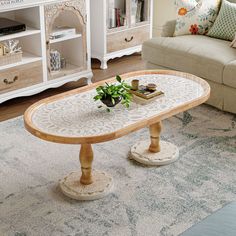 a living room with a couch, coffee table and bookshelf