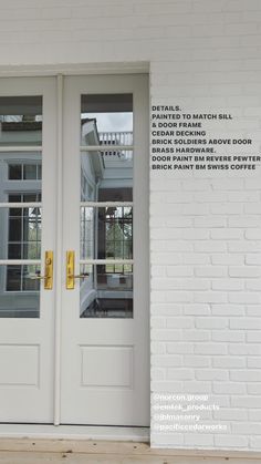 the front door to a white brick building with glass and yellow stickers on it