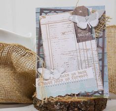 a piece of wood sitting on top of a table next to burlap bags