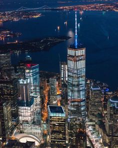 an aerial view of new york city at night with the empire building in the foreground