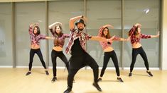 a group of people standing on top of a dance floor