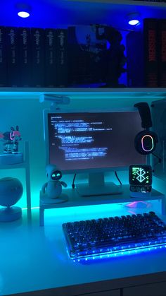 a computer desk with a keyboard, mouse and monitor lit up by blue light from below