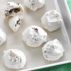 a white tray filled with cookies covered in frosting